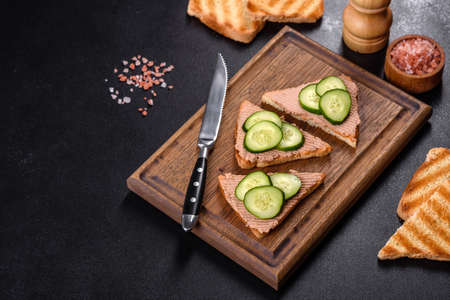 Delicious fresh sandwich with chicken liver pate with crispy toast, butter and cucumber. Quick...