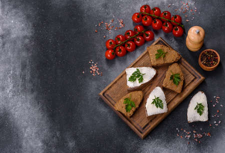 Fresh homemade chicken liver pate on bread over grey backgroundの写真素材