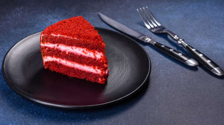 Red velvet cake, classic three layered cake from red butter sponge cakes with cream cheese frosting, American cuisineの写真素材