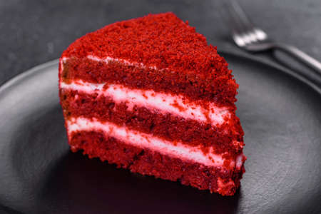 Red velvet cake, classic three layered cake from red butter sponge cakes with cream cheese frosting,...