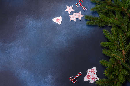 Crispy chocolate croissant with Christmas decorations on wooden cutting board on dark concrete...