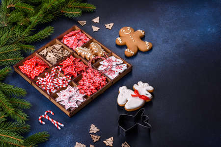 Christmas toys in white and red in a wooden sectional box against a dark concrete background. Home decorations for Christmas holidayの写真素材