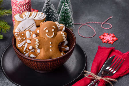 Gingerbread, Christmas tree decorations, dried citrus fruits on a gray concrete background to prepare a festive Christmas tableの写真素材
