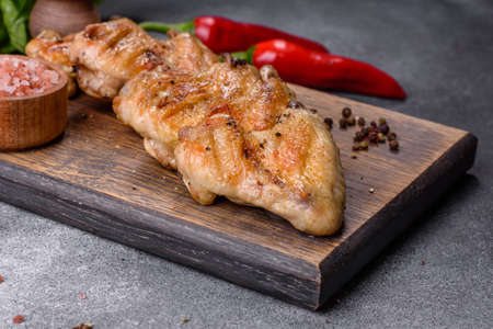 Baked chicken wings served with different sauces and lemon. gray backgroundの写真素材