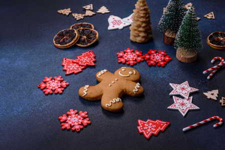 Christmas decorations and gingerbreads on a dark concrete table. Preparing and decorating the house for holidaysの写真素材