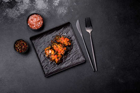 Dolma, stuffed grape leaves with rice and meat on a dark background. Caucasian and Turkish cuisine