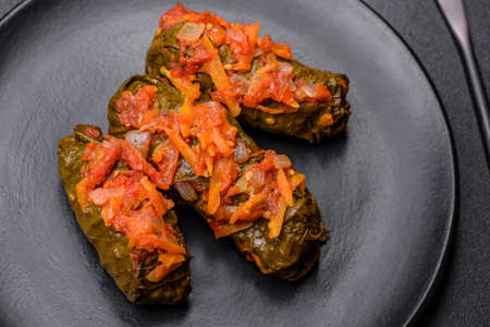 Dolma, stuffed grape leaves with rice and meat on a dark background. Caucasian and Turkish cuisineの写真素材