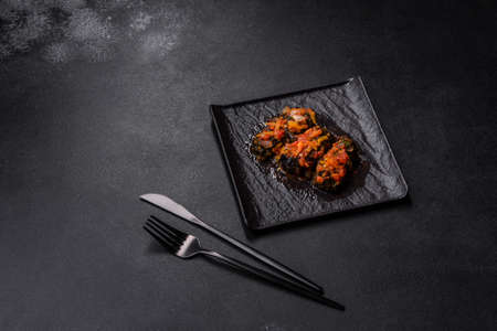 Dolma, stuffed grape leaves with rice and meat on a dark background. Caucasian and Turkish cuisine