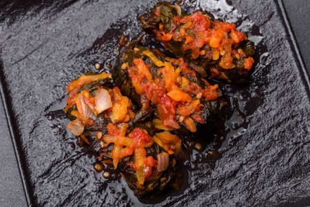 Dolma, stuffed grape leaves with rice and meat on a dark background. Caucasian and Turkish cuisineの写真素材