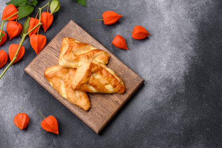 Delicious fresh cornmeal pastries with homemade cheese on a wooden cutting board. Delicious healthy breakfastの写真素材