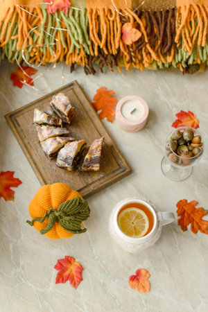 Homemade cake on a white background near the window close-up and copy space. Charlotte in the morning on the tableの写真素材