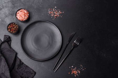 Black cutlery on a concrete dark table. Dining table preparationの写真素材