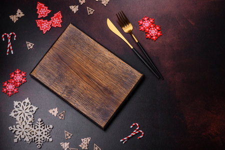 Christmas decoration elements as well as gingerbread on a brown concrete background. Preparing a...