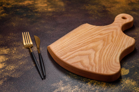 An empty brown ceramic plate on a dark concrete brown background. Preparing the Dinner Tableの写真素材