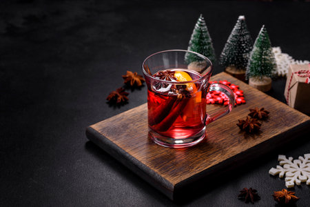 Christmas mulled red wine with spices and fruits on a concrete table. Traditional hot drink at Christmas timeの写真素材
