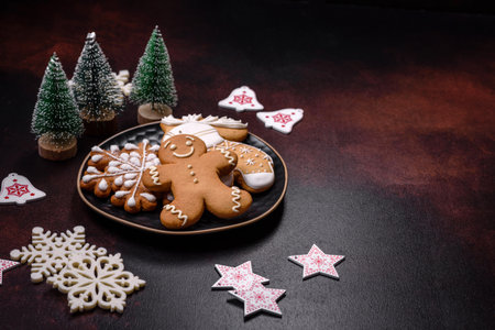 Home festive Christmas table decorated by toys and gingerbreads on a dark concrete backgroundの写真素材
