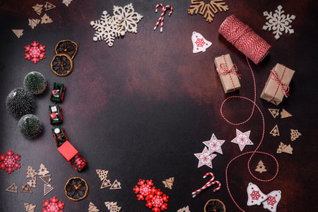 Home festive Christmas table decorated by toys and gingerbreads on a dark concrete background