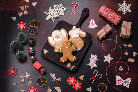 Home festive Christmas table decorated by toys and gingerbreads on a dark concrete background