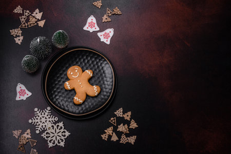 Home festive Christmas table decorated by toys and gingerbreads on a dark concrete background