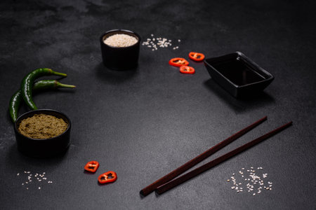 Delicious Asian teriyaki meat with red and green bell peppers and sesame seeds close-up on a plate on the tableの写真素材