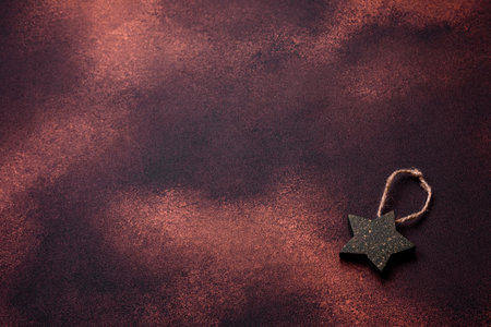 Beautiful textured dark concrete background with star shaped Christmas tree toy. Preparing to celebrate the new yearの写真素材