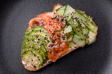 Delicious bruschetta with salmon, avocado and cucumberの写真素材