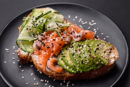 Sandwich with salmon, avocado and cucumber. healthy food backgroundの写真素材