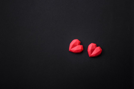 Delicious sweet heart shaped chocolate candies on a dark concrete background. valentines day celebrationの写真素材