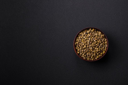 Spice, all spice green in a wooden bowl on a black concrete background. asian foodの写真素材