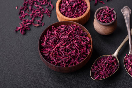 Dried beets in small slices in a wooden bowl on a black concrete background. asian food