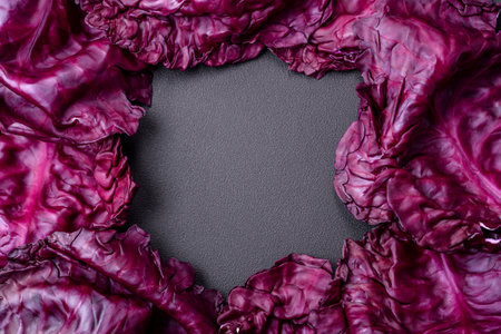 Fresh beautiful red cabbage with textured leaves on a dark concrete background. Vegetarian cookingの写真素材