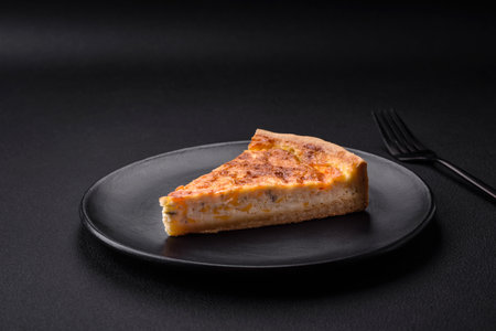 Beautiful delicious quiche pie with four types of cheese with spices and herbs on a dark concrete...