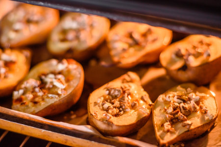 Delicious baked pear with dorblu cheese, walnut and honey on a textured concrete background. Vegetarian dishの写真素材