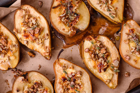 Delicious baked pear with dorblu cheese, walnut and honey on a textured concrete background. Vegetarian dishの写真素材