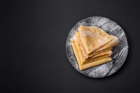 Delicious fresh baked pancakes with honey and fruits on a textured concrete background. Useful healthy foodの写真素材
