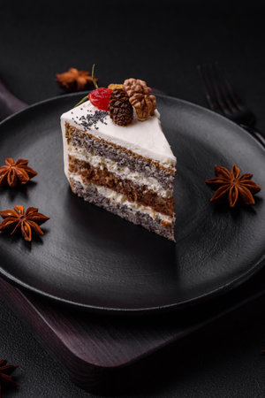 Delicious beautiful piece of cake with cream and berries on a black ceramic plate on a dark concrete backgroundの写真素材
