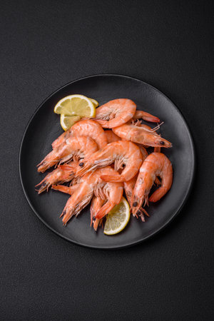 Tiger shrimp or langoustine boiled with spices and salt on a dark concrete backgroundの写真素材