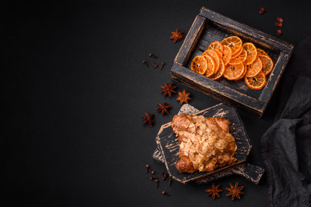 Fresh crispy croissant with almond chips and chocolate filling on a dark concrete backgroundの写真素材