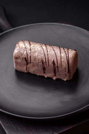 Delicious sweet cheese with syrup covered with chocolate and nuts on a ceramic plate on a dark...