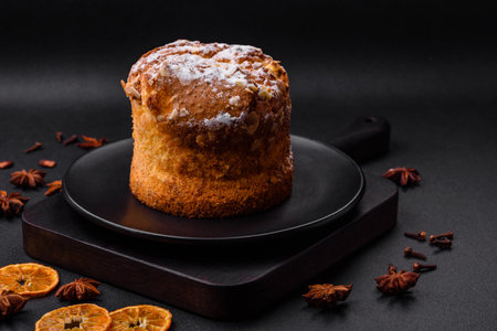 Delicious fresh christmas pie with fruit and raisin panettone on a dark concrete backgroundの写真素材