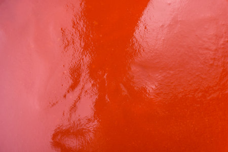 Delicious fresh gazpacho with breadcrumbs, salt and spices in a ceramic plate on a dark concrete backgroundの写真素材