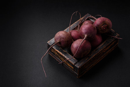 Fresh raw beetroot in the form of tubers on a textured concrete background. Vegetarian Ingredientsの写真素材