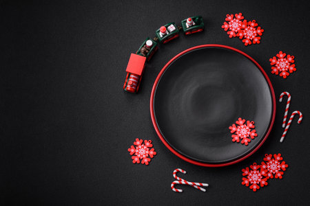 Beautiful bright colorful homemade gingerbread cookies on a ceramic plate on a dark concrete backgroundの写真素材