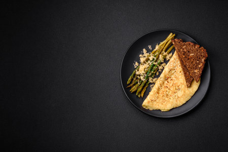 Delicious nutritious breakfast consisting of asparagus, scrambled eggs, salt, spices and herbs on a...
