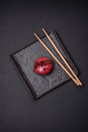 Delicious sweet colorful mochi desserts or ice cream with rice dough and toppings on a dark concrete backgroundの写真素材