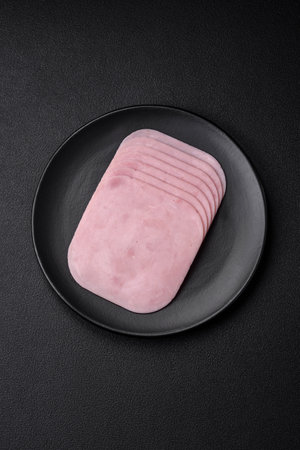 Delicious ham sliced with salt, spices and herbs as ingredients for making sandwiches