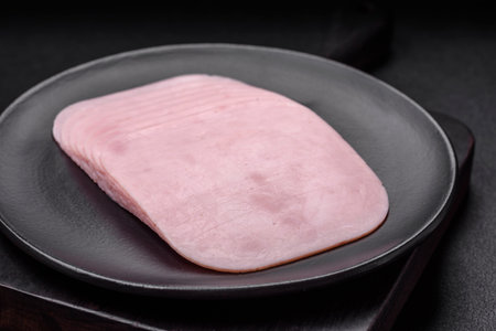 Delicious ham sliced with salt, spices and herbs as ingredients for making sandwichesの写真素材