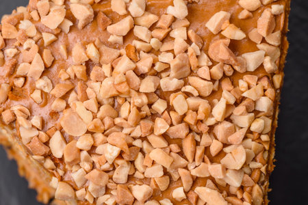 Delicious sweet puff waffle cake with cream and nuts cut into pieces on a textured concrete backgroundの写真素材