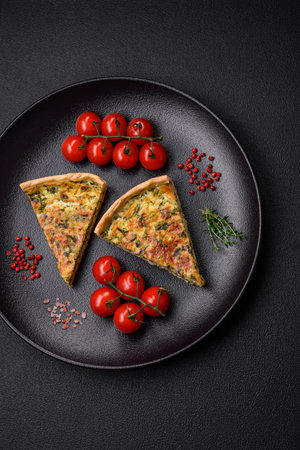 Delicious fresh quiche with broccoli, cheese, spices and herbs cut into pieces on a dark concrete...