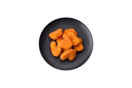 Delicious fresh crispy chicken nuggets on a dark concrete background. Unhealthy food, fast foodの写真素材